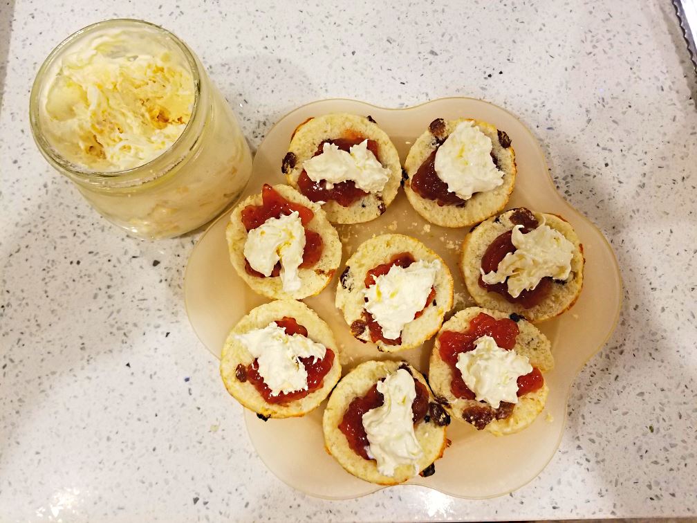 Scones with strawberry jam and home-made clotted cream, ready to eat. These scones are served Scones with strawberry jam and home-made clotted cream, ready to eat. These scones are served