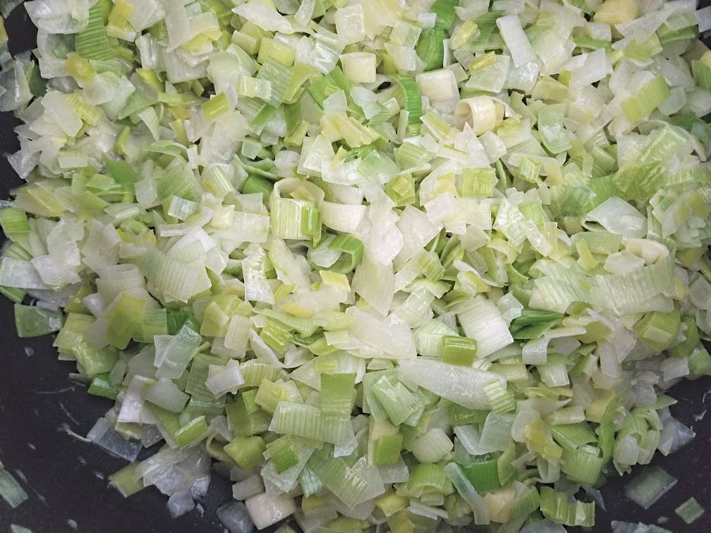 Leeks and onions cooking in the pot.