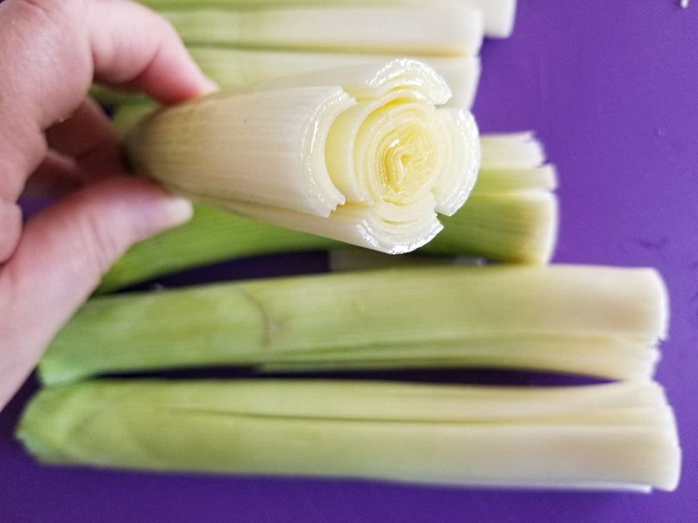 To remove grit I slice the leeks and fan them out.